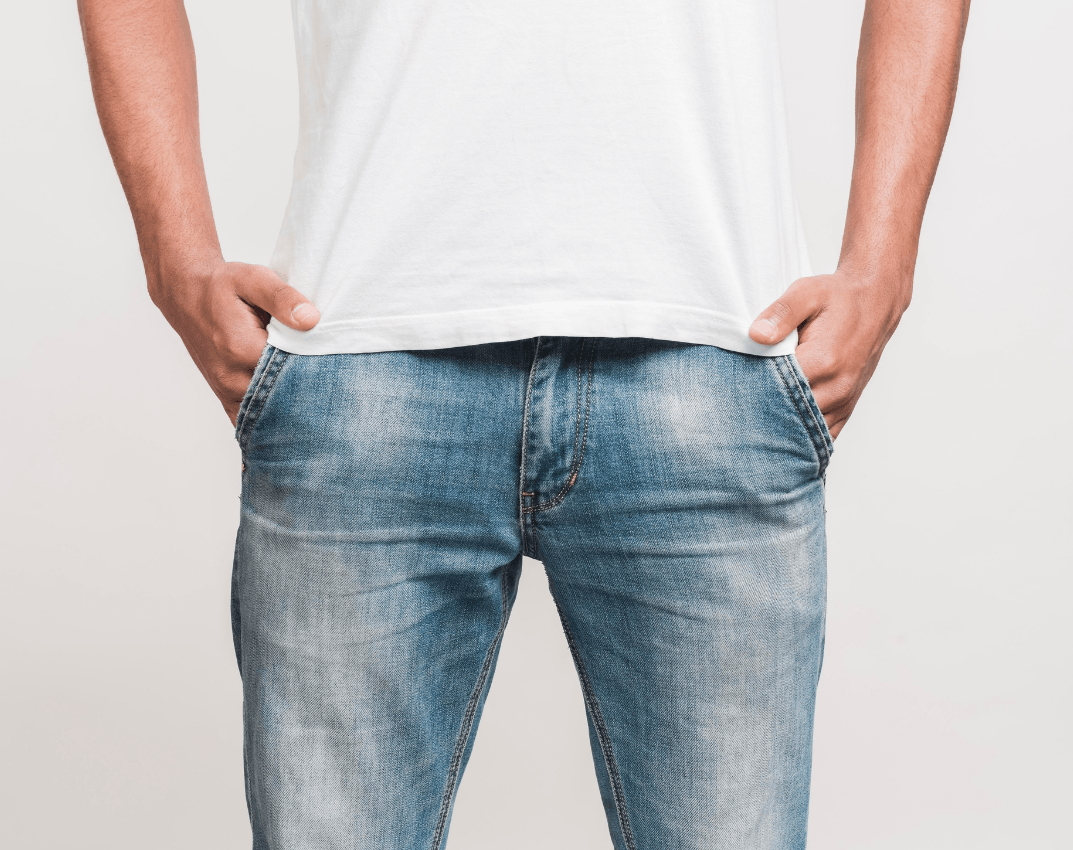 Man standing with his hands in his jeans pockets, illustrating an area where prostate or pelvic health conditions may contribute to premature ejaculation.